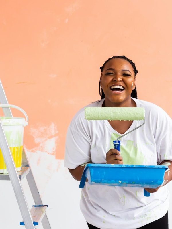 smiling-african-american-woman-painting-interior-wall-of-home-renovation-repair-and-redecoration.jpg
