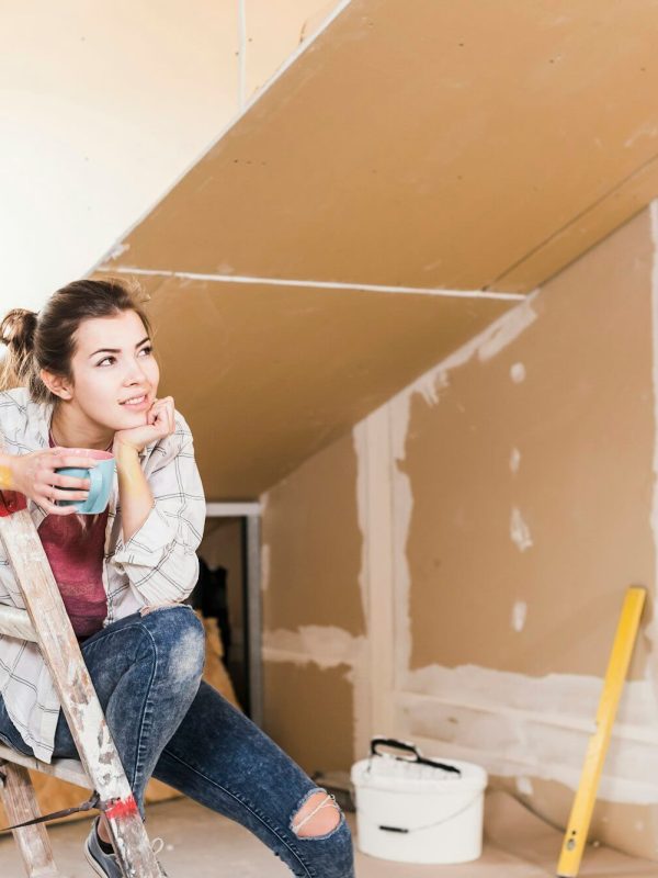 young-woman-contemplating-the-renovation-of-her-new-home.jpg